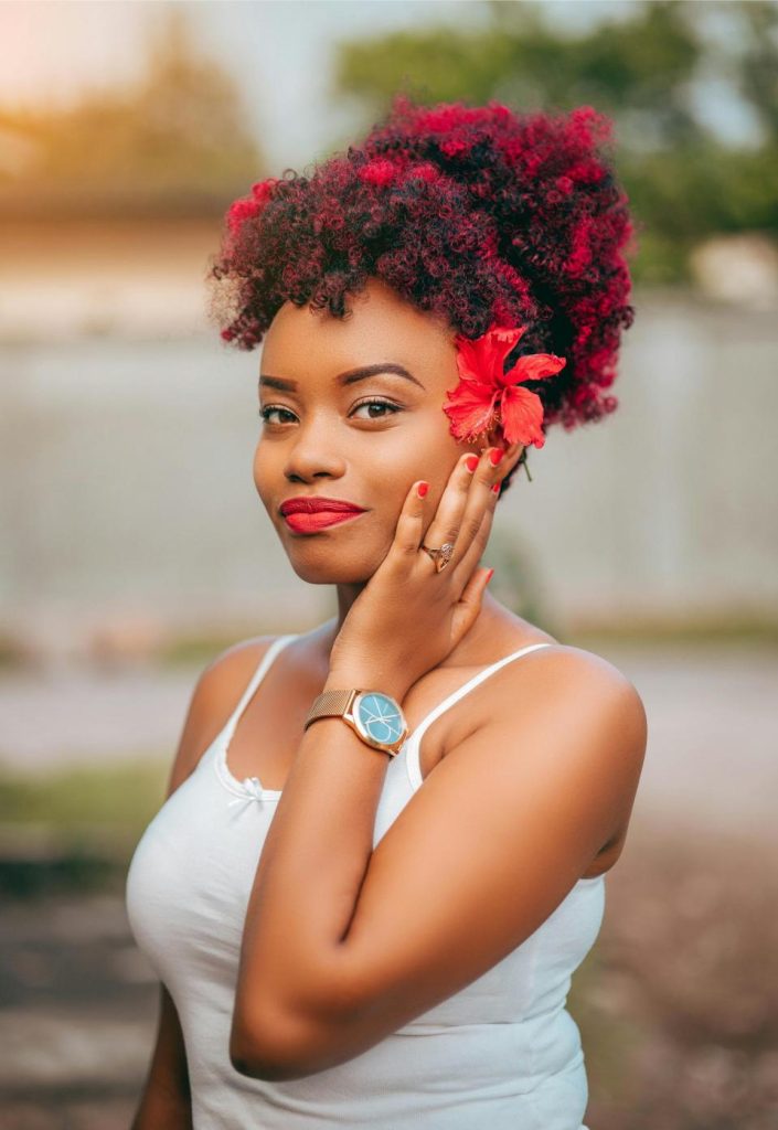 a woman with a red flower in hair